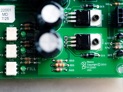 Circuit boardlige A 4x3 image of a green circuit board with the Newco Logo in the bottom right coner
