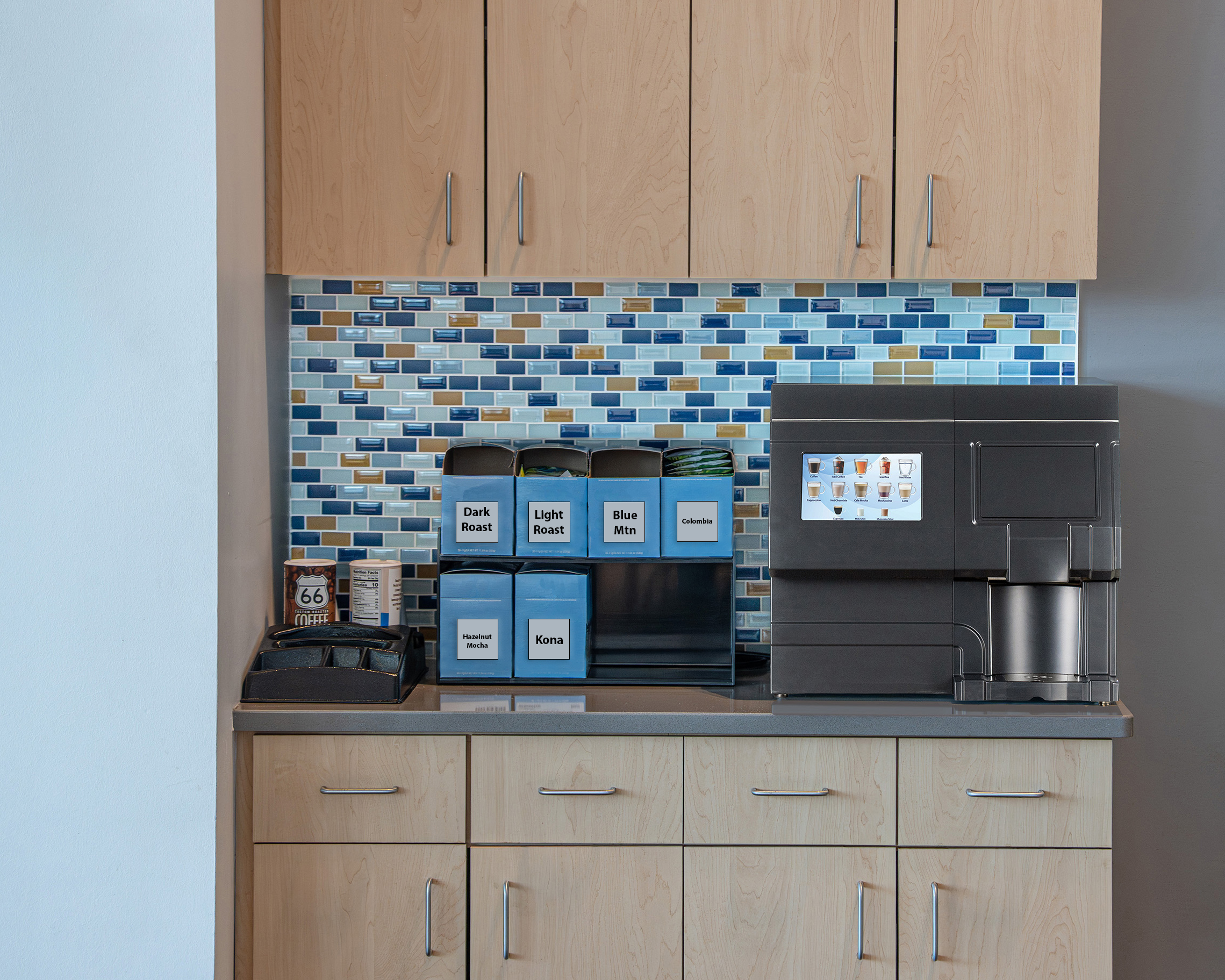CX-Touch-Horizon-Countertop A CX Touch Horizon sits on a countertop, below kitchen cabinets, beside a rack of coffee pods.
