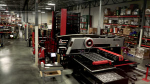 Overhead shot of the Amada laser/punch press machine on factory floor.