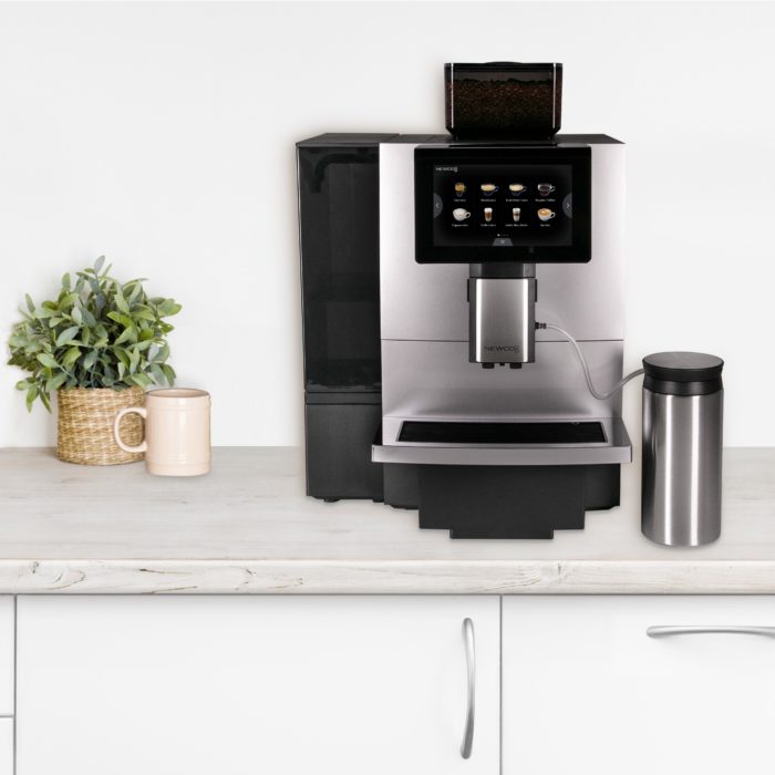 Café Espresso machine sitting on a counter with the milk thermos attached to the machine